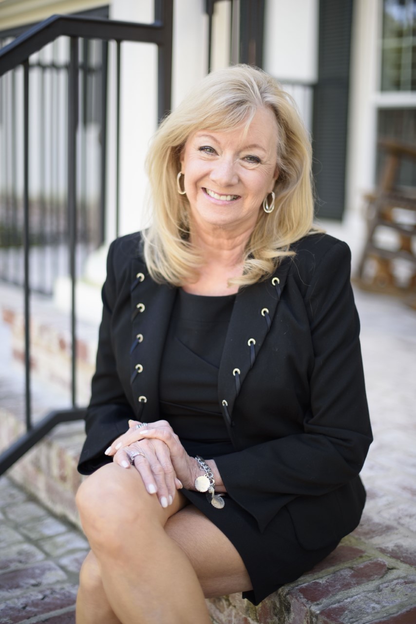 Laurie Campbell smiling on a front porch